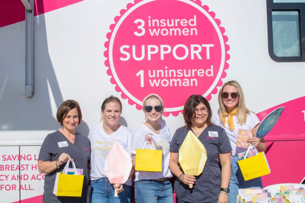 Women in front of sign that says 3 insured women support 1 uninsured woman
